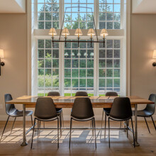 dining room table in front of a two story window